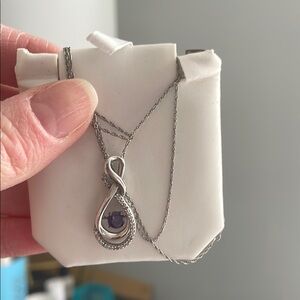 Necklace with suspended purple stone